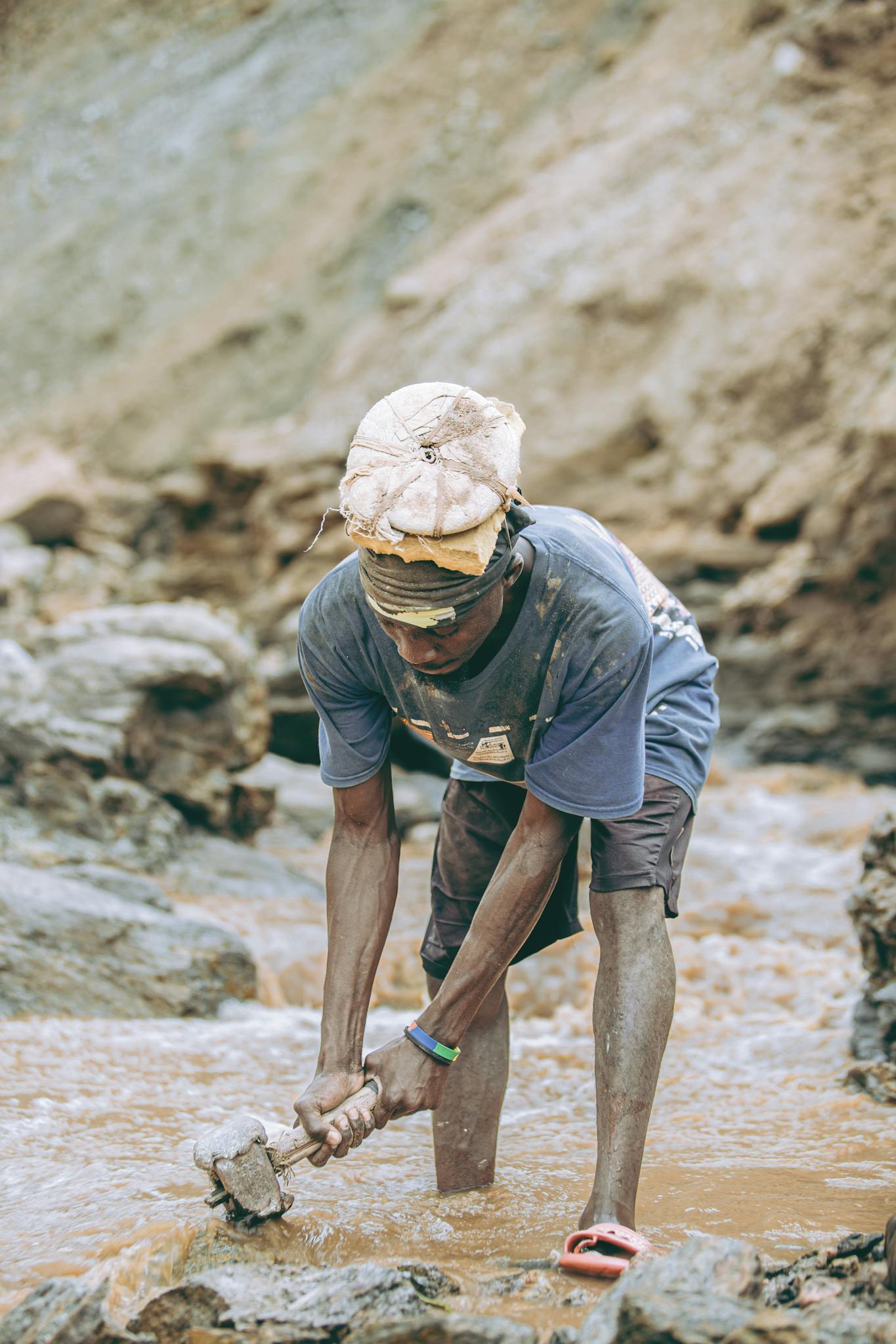 A dedicated miner in rugged terrain, exemplifying hard work outdoors.
