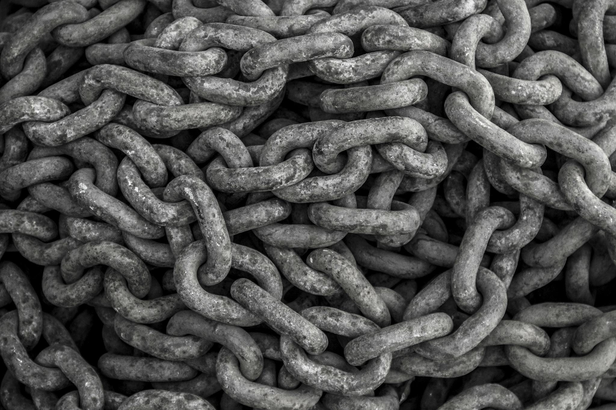 Detailed close-up view of piled iron chains showcasing heavy and textured metal links.